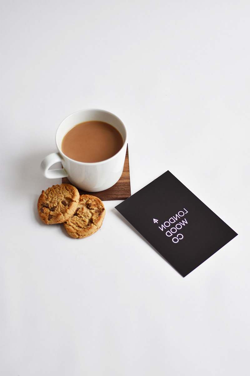 cup white ceramic cup on brown wooden coaster beverage